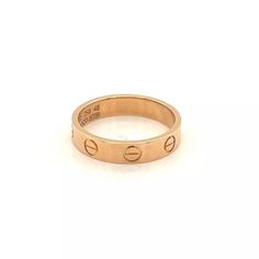 This is an elegant authentic band ring by Cartier from the LOVE collection in the mini style. It is crafted from solid 18k pink gold in a high polished finish and has the iconic screw top motifs around the entire band. It is fully signed by the designer with the serial number, ring size and metal content.    Currently retails for $1,250 - Includes Cartier certificate.    Brand:  Cartier     Hallmark: Cartier 750 48 HW5520  Material:  18k pink gold  Measurement:  3.6mm wide x 1.5mm thick  Ring Si Luxury Rose Gold Engraved Promise Ring, Cartier Rose Gold Wedding Ring, Luxury Rose Gold Rings Stamped 14k, Luxury Rose Gold Couple Rings For Promise, Luxury Cartier Rose Gold Ring, Cartier 14k Gold Ring With Vvs Clarity, Luxury Rose Gold Engraved Ring Stamped 14k, Luxury Hallmarked Rose Gold Engraved Ring, Luxury 14k Rose Gold Engraved Ring