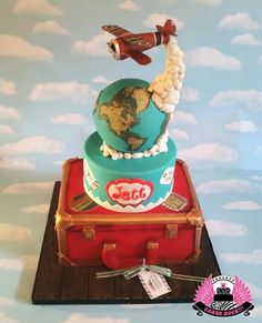 a cake that is shaped like an airplane and has the earth on top of it