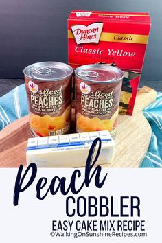 peach cobbler cake mix recipe on a cutting board with two cans of peaches in the background