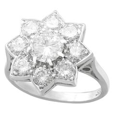 A stunning vintage 1940s 1.87 carat diamond and 18 karat white gold, platinum set floral cluster ring; part of our diverse diamond jewelry and estate jewelry collections. This stunning, fine and impressive vintage diamond ring has been crafted in 18k white gold with a platinum setting. The platinum set floral cluster design is ornamented with a central feature 0.82 Ct transitional modern brilliant round cut diamond, eight claw set in subtle relief. The feature diamond is surrounded by eight 'pet Luxury White Gold Heirloom Cluster Ring, Luxury Art Deco Diamond Cluster Ring, Luxury Timeless Cluster Diamond Ring, Luxury Polished Cluster Ring, Luxury Collectible Cluster Ring With Prong Setting, Luxury Cluster Diamond Ring In Fine Jewelry Style, Luxury Cluster Diamond Ring, Fine Jewelry Style, Luxury White Gold Cluster Ring With Rose Cut Diamonds, Luxury White Gold Cluster Ring With Accent Stones