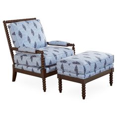 an upholstered chair and footstool are shown in this image, with blue patterned fabric