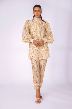 Wear this light fawn floral printed khaddi silk co-ord set in style this season and stay on trend. The pleated detailing, high neckline and puffy sleeves on the shirt add exaggerated flair. Co Ord Set Pattern, Shirt Coord Set, Sets With Blouson Long Sleeves, Printed Co Ord Set Pakistani, Spring Sets With Blouson Sleeves, Elegant Floral Print Pant Set For Spring, Silk Sets For Spring Daywear, Silk Floral Print Long Sleeve Sets, Silk Sets For Daywear