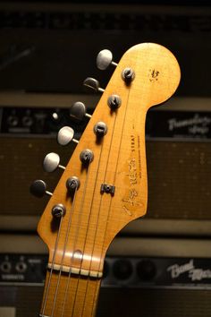 an electric bass guitar hanging from the wall