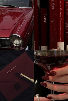 a woman holding a wine glass in front of a red car and stack of books