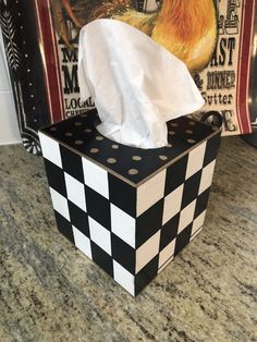 a tissue dispenser sitting on top of a counter