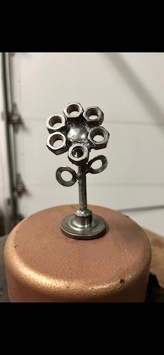 a metal object sitting on top of a wooden table