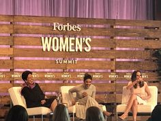 three women sitting on chairs in front of a wooden panel with the words footles women's summit