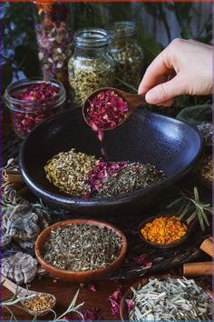 a person scooping out herbs from a bowl