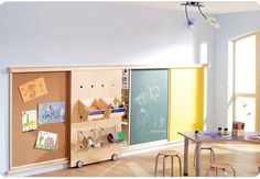 a child's playroom with various toys on the walls and tables in front of it