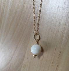 Mother of Pearl Shell Bead Pendant and Chain, 14K Gold Filled Cream Beige Organic, Natural Beach Necklace, Round Dangle Our round bead, mother of pearl pendant and chain are classic, and versatile. Mother of pearl (MOP) shimmers as the light hits the surface, so as you move, your pendant will reflect the light.  MOP comes from a natural shell and is different than cultured pearls. Features: - Length of Chain: Choose either 16 or 18 inches, go to the pull down menu to select your chain length. - Beach Necklaces, Shell Bracelet, Shell Beads, Cultured Pearls, Beaded Pendant, Pearl Pendant, Pearl Beads, Layered Necklaces, Mother Of Pearl