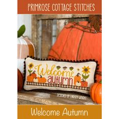 a welcome autumn pillow with pumpkins on it