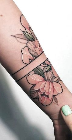 a woman's arm with flowers on it, and a cross in the middle