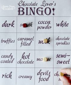 a person is holding a chocolate lover's bingo game