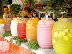 several large jars filled with liquid sitting on top of a counter