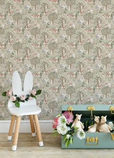 two white bunny statues sitting in front of a wallpapered with flowers and trees