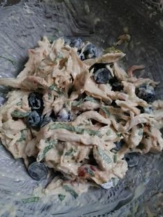 a bowl filled with pasta and blueberries on top of a table