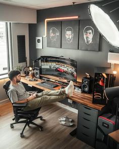 a man sitting at a desk with his feet up in front of the computer monitor