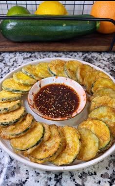 zucchini chips on a plate with dipping sauce