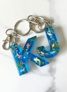 the letter k is made out of plastic and has an animal theme on it's side