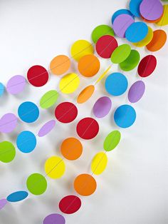 multicolored paper confetti garland on white background