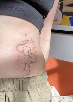 a woman's stomach with a small elephant tattoo on the side of her belly