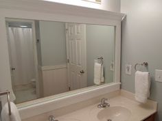 a bathroom with two sinks and a large mirror