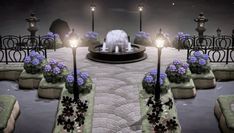 a white dog standing in front of a fountain with flowers on it's sides