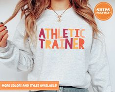 Our handmade Athletic Trainer sweatshirts ship the same or the next business day and are made to order just for you! Our trendy Athletic Trainer sweatshirts are made from an ultra-soft 50/50 blend which will quickly make this your go-to crewneck! All our garments are printed with premium eco-friendly water-based ink. Unlike cheap vinyl transfers that peel off, our inks become part of the garment which makes them feel better and last longer! ♥ Sizing ♥ All our sweatshirts are unisex sizing. For a Sporty Workout T-shirt For Fall, Fall Workout Tops With Letter Print, Fall Athleisure T-shirt For Workout, Fall Workout Sweatshirt With Letter Print, Fall Relaxed Fit Letter Print Activewear, Fall Activewear With Letter Print And Crew Neck, Fall Crew Neck Activewear With Letter Print, Athletic Heather Crew Neck Sweatshirt For Workout, Athletic Trainer