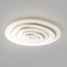 the ceiling light is white and has four circular lights