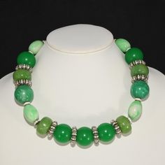 This is part of Chairish’s Costume Jewelry assortment.  Francoise Montague, a company associated with high quality French jewelry for decades, produced this necklace comprised of green resin beads in various colors and the unique combination of white rhinestone rondelles. Marked FM Paris, which is the mark of Francoise Montague. We believe this piece dates to the 1980s given the style and materials. Adjusts from about 17 to 20 inches long; largest beads measure just under 1 inch across. Elegant Green Resin Jewelry, Green Round Beads Costume Jewelry, Green Beaded Costume Jewelry Necklace, Elegant Green Round Beaded Necklaces, Elegant Green Round Beaded Necklace, Green Polished Round Beads Jewelry, Jade Necklace With Spacer Beads, Jade Necklace With Spacer And Round Beads, Green Resin Necklaces For Jewelry Making