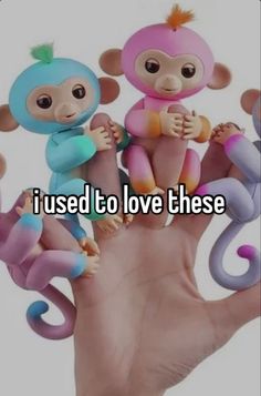 two monkeys sitting on top of a hand with the words i used to love these