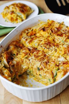 a casserole dish with cheese and spinach in it