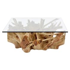 a glass and wood coffee table with wooden carvings on it's sides, against a white background