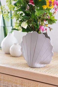 a vase filled with flowers sitting on top of a table