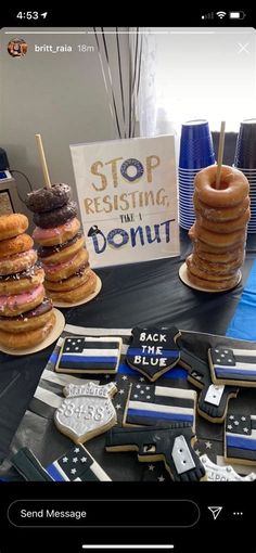 a table topped with lots of donuts covered in frosting