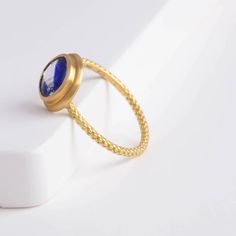 Description One-of-kind 18k yellow gold ring with a unique bi-color oval sapphire with darker and light blue hues, set in an east-west setting. The color of this sapphire is like seeing where the sky and the ocean meets at the horizon. This ring is in a rope design, adding a little more detail to every part of the ring. Details 18k Yellow Gold Size of sapphire – 7.1 x 6.1 x 2.8 mm (1.17 ct) Made in Japan *Please note that due to the natural quality of the stones, there may be inclusions, cracks, Fine Jewelry Sapphire Cabochon Ring, Fine Jewelry Blue Cabochon Sapphire Ring, Fine Jewelry Sapphire Ring With Cabochon Cut, Blue Cabochon Sapphire Ring In Fine Jewelry Style, Fine Jewelry 14k Gold Sapphire Ring With Oval Cabochon, Blue Cabochon Sapphire Ring, Gold Sapphire Ring With Oval Cabochon, Yellow Gold Sapphire Ring With Bezel Setting, Oval Cabochon, Gold Tanzanite Round Rings