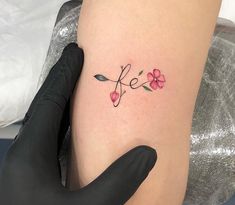 a woman's arm with a tattoo that says life on it and flowers in the middle