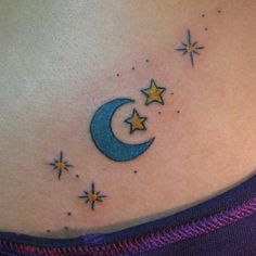 a woman's stomach with a crescent and stars tattoo on it