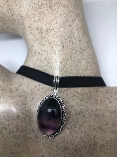 Genuine Amethyst Necklace Low content Silver with a Rhodium finish NOT 925 Hangs on a black velvet ribbon Can adjust around the neck Can be hung on silver chain Large Cabochon Amethyst All jewelry is shipped free in the US in a nice gift box. Check out our over a THOUSAND great reviews Elegant Black Amethyst Jewelry, Black Amethyst Jewelry For Formal Occasions, Black Sterling Silver Choker For Gift, Black Sterling Silver Choker As Gift, Formal Black Amethyst Jewelry, Elegant Black Amethyst Necklace, Black Velvet Ribbon, Bib Necklaces, Vintage Purple