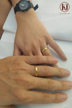 two people with wedding rings on their hands, one holding the other's hand