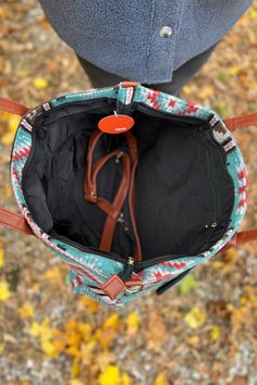 This tote is the perfect go to when packing for your next overnight trip. It features a top zipper closure, a detachable crossbody strap, and interior pocket. Super cute western inspired teal pattern. Added bonus detachable clutch for quick access to your essentials. 100% Polyester Dimensions: 19"L x 6"H x 7.5"D Western Purses And Handbags, Leather Pendleton Purse, Western Purses And Handbags Fabric, Western Crossbody Purse, Western Cross Body Purse, Teal Pattern, Weekender Tote, Crossbody Strap, Super Cute