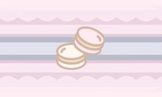 two cookies sitting on top of each other in front of a pink and blue striped background