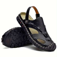 a pair of men's black sandals with braiding on the soles and an open toe