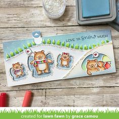 the bear family stamp set is displayed on a wooden table with markers and ink pens