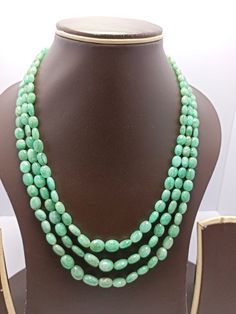 Awesome 314 Carat Fine Quality Natural  Emerald  Smooth Oval Gemstone Necklace Adjustable code Stone  :Natural  Emerald Shape :-  oval Necklace - 18 inch 3 line string Size :- 4x5mm to 9x11mm Weight :- 314 carat Polish :- Handmade Purity :- 100% Natural Gemstone Purity :- AAA color - green makes a great gift for your loved ones. It is known as the 'love stone' as the message it emits is the strong vibration of unconditional love, joy, warmth and healing. As quartz crystals are profound amplifiers of energy, it may help to kindle happiness, love, romantic feelings and sensuality. It is good for people in public dealing  Click below to see live stock:  https://www.etsy.com/au/shop/ShakugemsStore?ref=search_shop_redirect If for any reason you are not satisfied with your purchase. You can retu Green Oval Gemstone Beads Necklace, Oval Emerald Gemstone Beads Necklace Gift, Green Oval Gemstone Bead Necklace, Green Oval Gemstone Beaded Necklace, Oval Green Gemstone Beaded Necklaces, Green Oval Gemstone Beaded Necklaces, Handmade Oval Emerald Necklace, Oval Necklace, Quartz Crystals