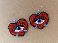 Red hearts with blue eyes and blue teardrops. They are 1.5 inches long, not including the hooks, and 1.75 inches wide. Halloween Earrings Beaded, Heart Beaded Earrings, Beaded Earrings Native, Beaded Jewlery, Earrings Beaded, Halloween Earrings, Red Hearts, Heart Beads, Seed Bead