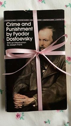 a book with a pink ribbon tied around it