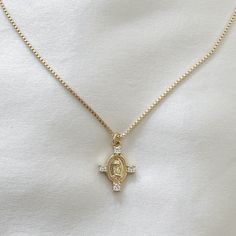 Mary pendant necklace with cubic zirconia details. Perfect to wear alone or layer with other necklaces. 14k Gold Filled Chain 14k Gold Filled Charm Charm: 22.5mm x 13.6mm x 3.1mm Chain length: 20" Chain Diameter: 1.4mm Lobster clasp closure Hypoallergenic Water resistant & tarnish free Nickel & lead free Figaro Chain Necklace, Sustainable Jewelry, Gold Filled Jewelry, Gold Filled Chain, Ring Bracelet, Chain Lengths, Chain Length, Lobster Clasp, Sterling Silver Jewelry