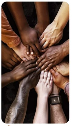 a group of people's hands in the middle of a circle with their fingers together