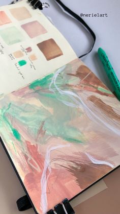 an open notebook with some paint on it